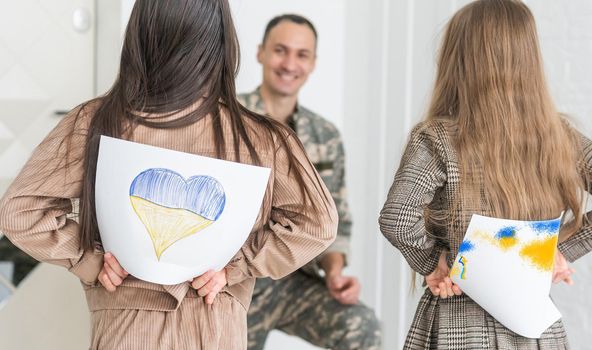 Happy Ukrainian soldier in military, cheerful daughter, Ukrainian veterans of Russian-Ukrainian, Independence Day.