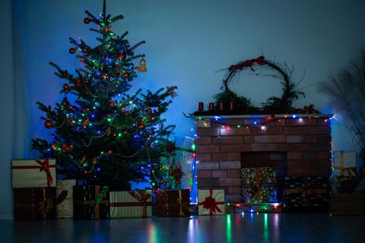 Shiny Christmas tree lights. Twilight in the living room at home. Decoration for Christmas.