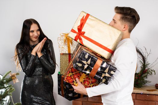 The fianc e's partner decided to give lots of gifts during Christmas. The fianc e surprised by the amount of presents. Shiny black dress.