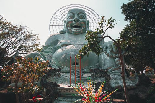 Low angle view of a giant Smiling Buddha Statue in Linh An Pagoda in Da lat, Vietnam