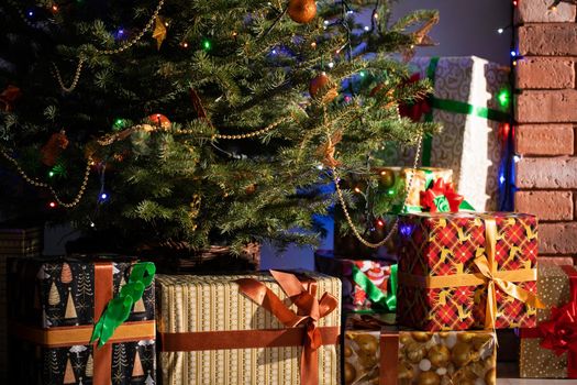 A Christmas tree in the foreground and a decorated fireplace in the second. Unusual Christmas.