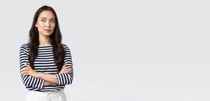 Lifestyle, people emotions and casual concept. Confident nice smiling asian woman cross arms chest confident, ready to help, listening to coworkers, taking part conversation.