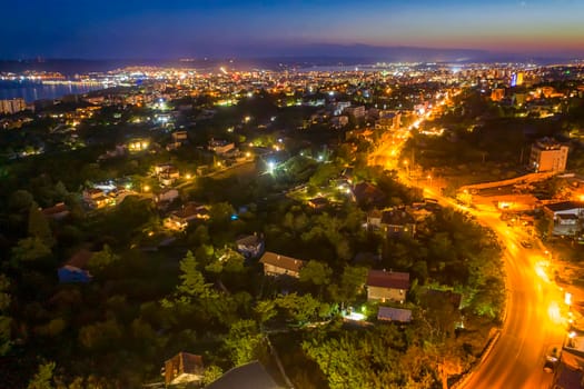 Aerial view from the drone of the illuminated city at twilight. Varna, Bulgaria