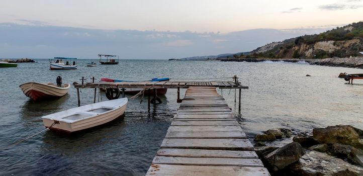 panoramic view of wooden pier and  boats 