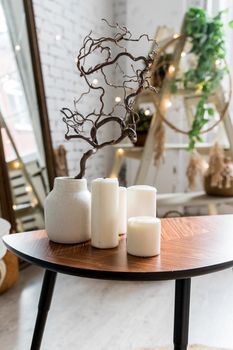white candles on wooden coffee table in cozy living room interior