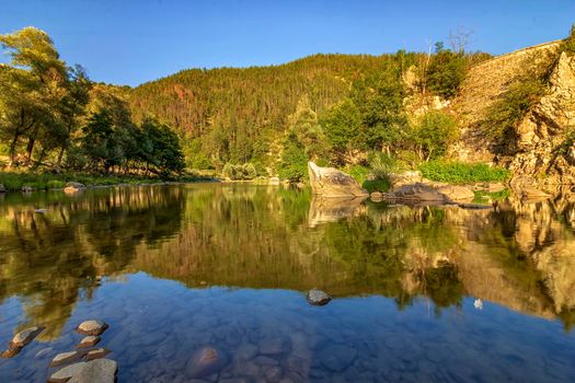 Beautiful reflections in the water of a mountain river