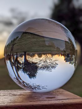 Reflections of the sunset in a cloudy day in a crystal ball 