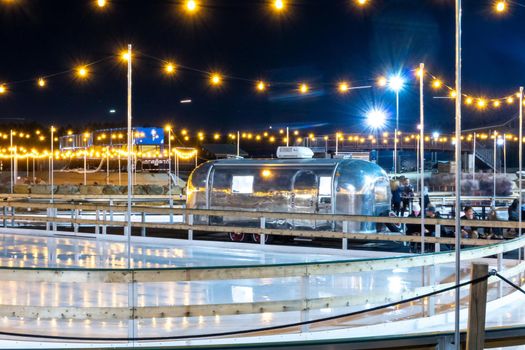 beautiful outdoor ice rink at night with lights