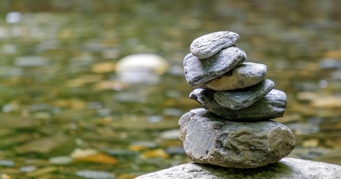 Balancing pebbles from river stones stack. Tranquil Concept. Blurred background