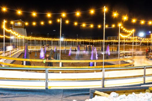 beautiful outdoor ice rink at night with lights