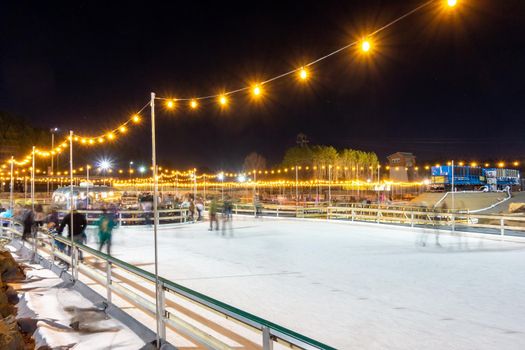 beautiful outdoor ice rink at night with lights