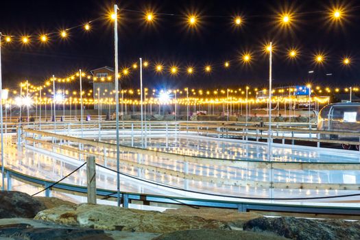 beautiful outdoor ice rink at night with lights