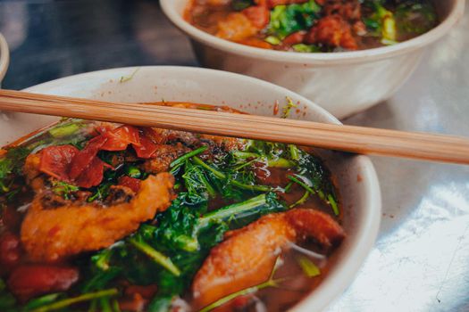 Close up of a bowl of Vietnamese Fried Fish Vermicelli Noodle Soup called Bun Ca