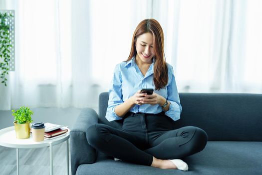 internet learning, online shopping, selling, meeting, information searching, Portrait of young Asian woman using smartphone mobile to work at home