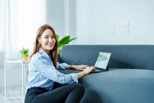 internet learning, online shopping, selling, meeting, information searching, Portrait of young Asian woman showing smiling face while using tablet to work at home