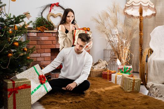 An unexpected gift from a fianc e while decorating a Christmas tree for Christmas. December Christian holidays.