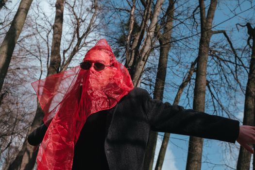 Superhero man with red mask and sunglasses fashion fighter in the park