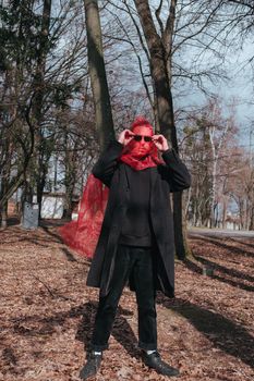 Superhero man with red mask and sunglasses fashion fighter in the park