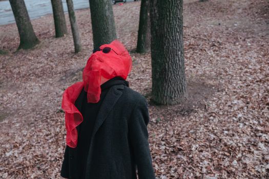 Superhero man with red mask and sunglasses fashion fighter in the park