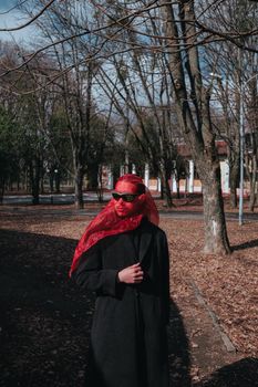 Superhero man with red mask and sunglasses fashion fighter in the park