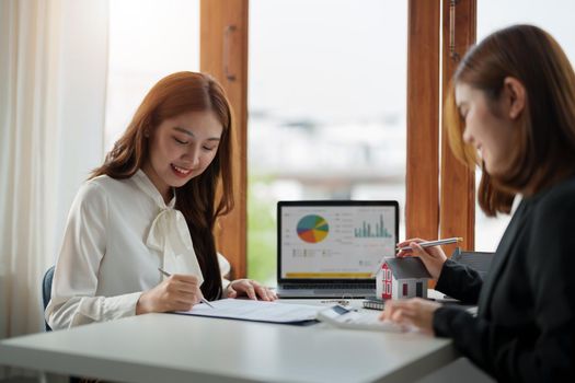 Real estate agent or bank officer describes the loan interest to the customer with home purchase contracts or on office loans and interest rates.