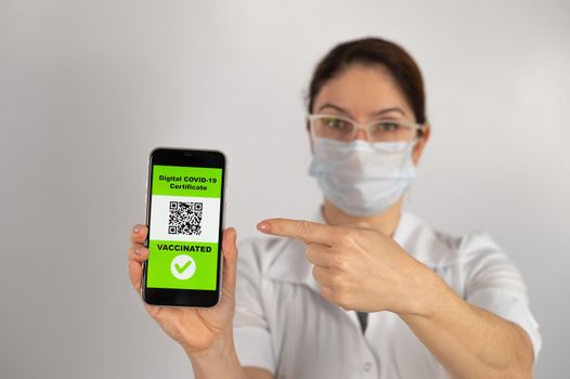 The doctor recommends vaccination and holds a smartphone with a QR code