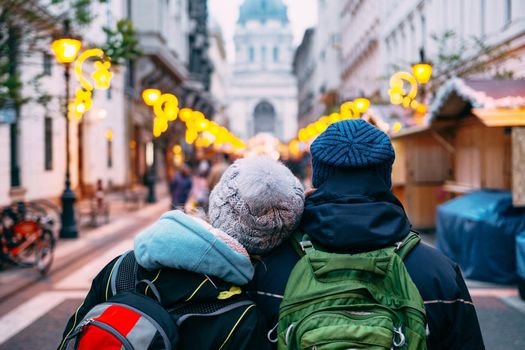 A couple of tourists in love walks around Budapest against the background of St. Stephen's Basilica. High quality photo