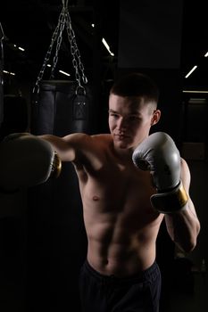 Blows boxer bag practices the The athlete glove black young professional boxing, from strong gloves in sport for fit hit, studio martial. Athletic active dark,