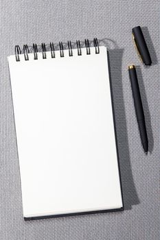 A white springboard for sketching is on a gray canvas texture. Black pen.