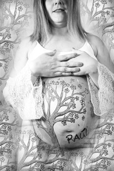 Eight months pregnant woman in dressing gown with drawing on her belly. No copy space