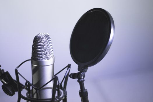 Professional microphone suspended in the air of professional studio