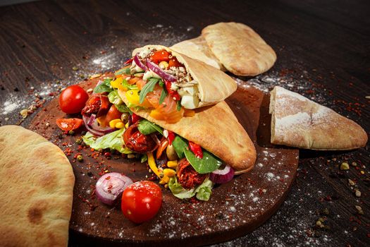 Doner kebab or pita on a wooden tray.