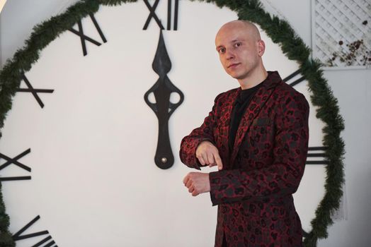 Bald guy in classic holiday wear showing that New year has come.