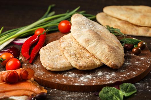 Doner kebab or pita on a wooden tray.