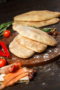 Doner kebab or pita on a wooden tray.