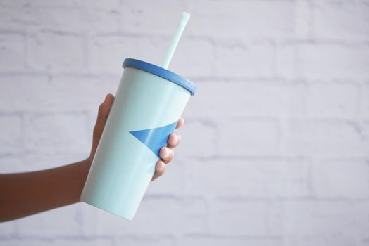 holding a reusable eco coffee cup with copy space