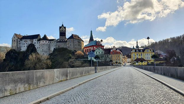 Panorama view of medieaval Loket Castle with the main road ahead to the centre of town Loket near spa city Karlovy vary.