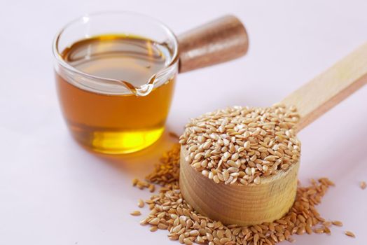 coking oil and seeds in a container on table .