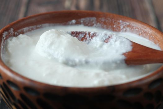 fresh yogurt in a bowl on table .