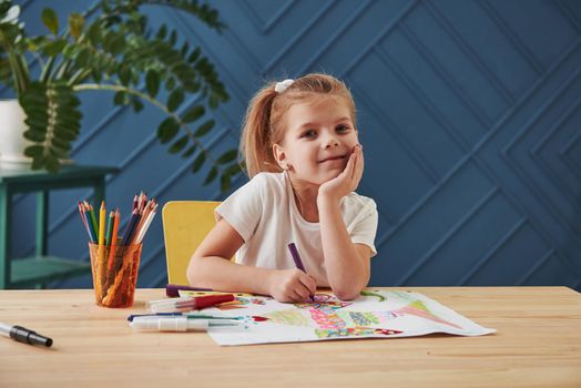 Nice portrait. Cute little girl in art school draws her first paintings by pencils and markers.