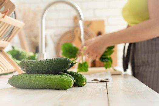 Preparing healthy foods. Healthy eating and dieting. Close up of table with green vegetables in the kitchen