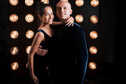 Happy couple posing for the portrait. Family business of magician tricks and shows.