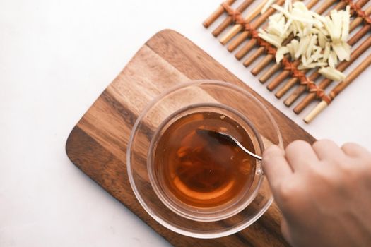 Top view of ginger tea on wooden background..