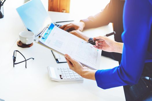 negotiation, analysis, discussion,asian female economist pointing out a document explaining the investment finance program to the company owner to plan marketing and hedging business risks