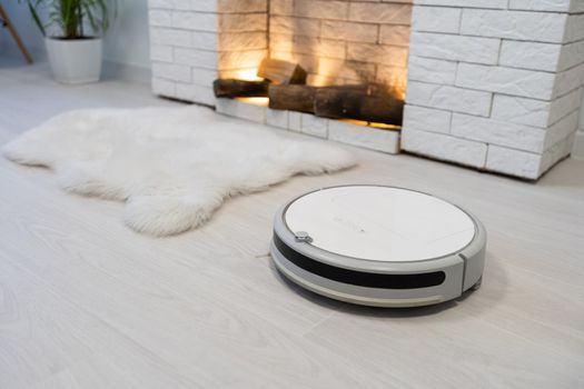 robotic vacuum cleaner on laminate wood floor smart cleaning technology.