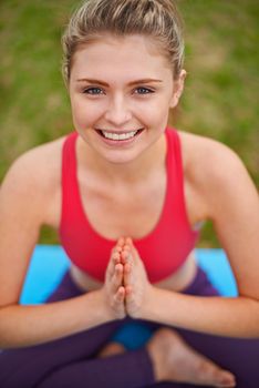 Shot of a young woman doing yoga in the outdoors.