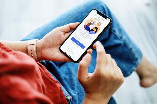 CHIANG MAI, THAILAND - Jan 30, 2022 : Female A working from home employee is downloading the Microsoft Teams social platform, ready for remote working in isolation from home