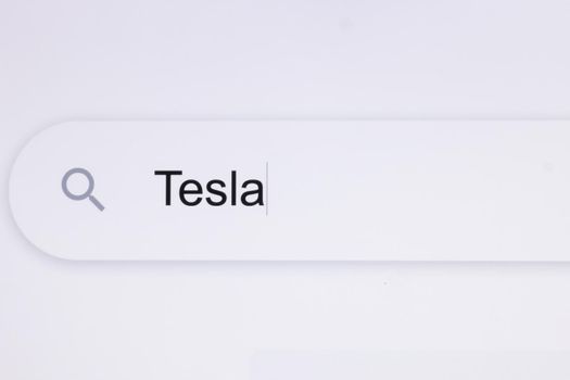 Typing Tesla Into Address Bar. Searching For an Online Network Website. Searching The World Wide Web Internet on a Computer. Monitor Screen View of Search for a Webpage.