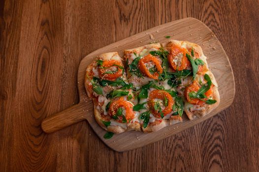 Pizza with salmon on roman dough with ruccola