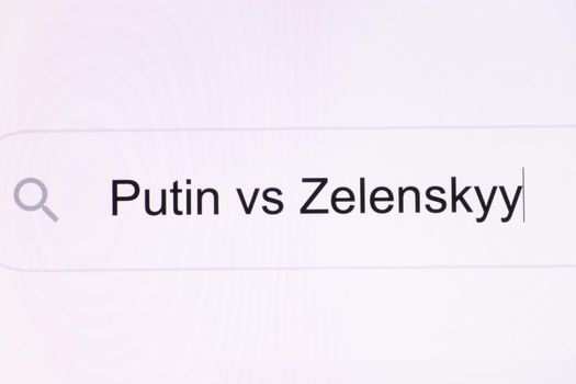 Close Up of searching for Putin vs Zelensky on the Internet. Putin vs Zelensky headline titles across international media in white background. President of Ukraine Volodymyr Zelensky vs Putin Russia